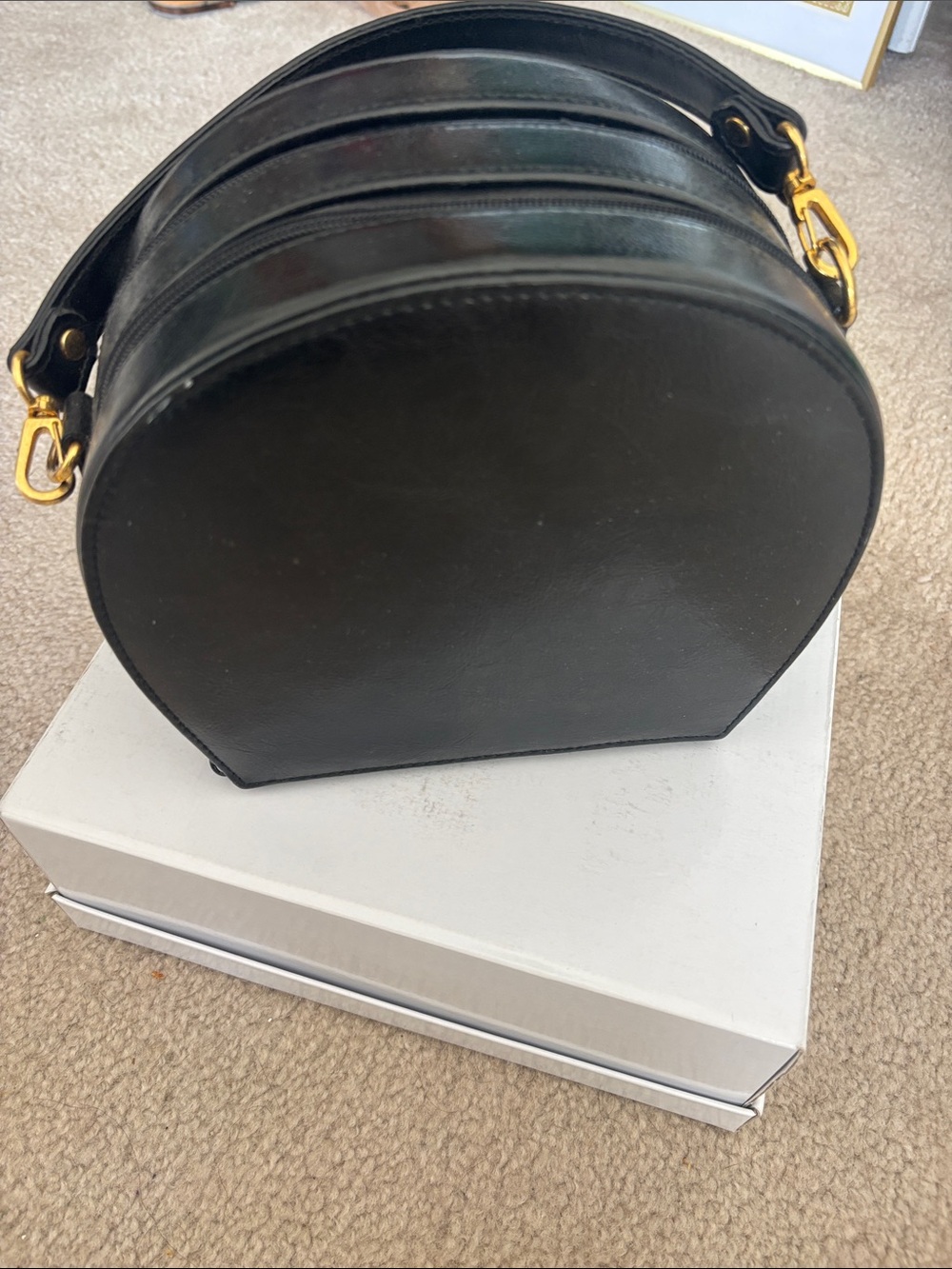 Structured Black Round Crossbody Bag with Gold Accents